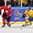 MALMO, SWEDEN - DECEMBER 26: Switzerland's Mirco Muller #5 skates with the puck while Sweden's Anton Karlsson #27 chases him down during preliminary round action at the 2014 IIHF World Junior Championship. (Photo by Andre Ringuette/HHOF-IIHF Images)